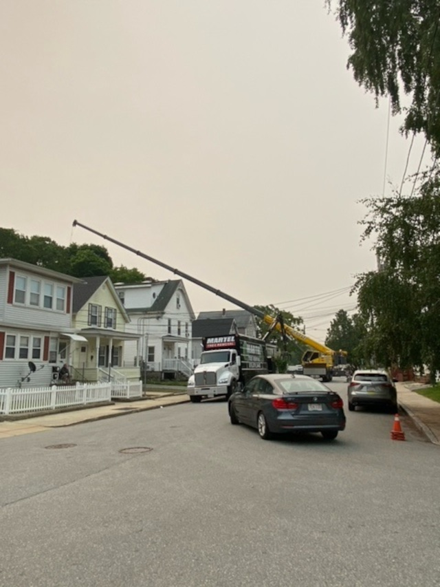 Martel Crane & Tree Service safely removed several large trees with the 100 ton crane from this neighborhood in Lowell, MA. 