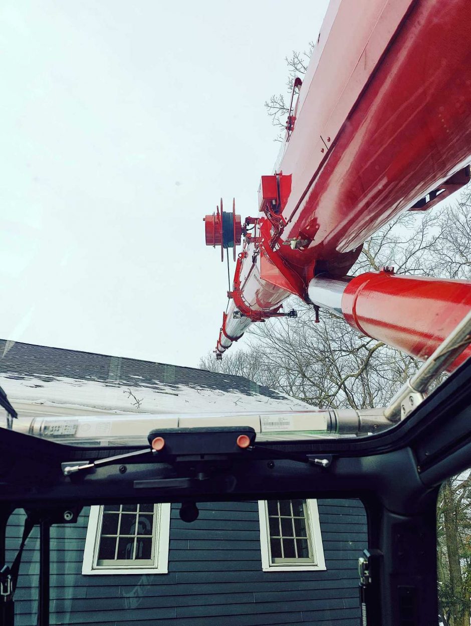 For this tree removal job in Chelmsford, MA, Martel Crane and Tree used the reach of the red crane to safely remove trees from the property.

