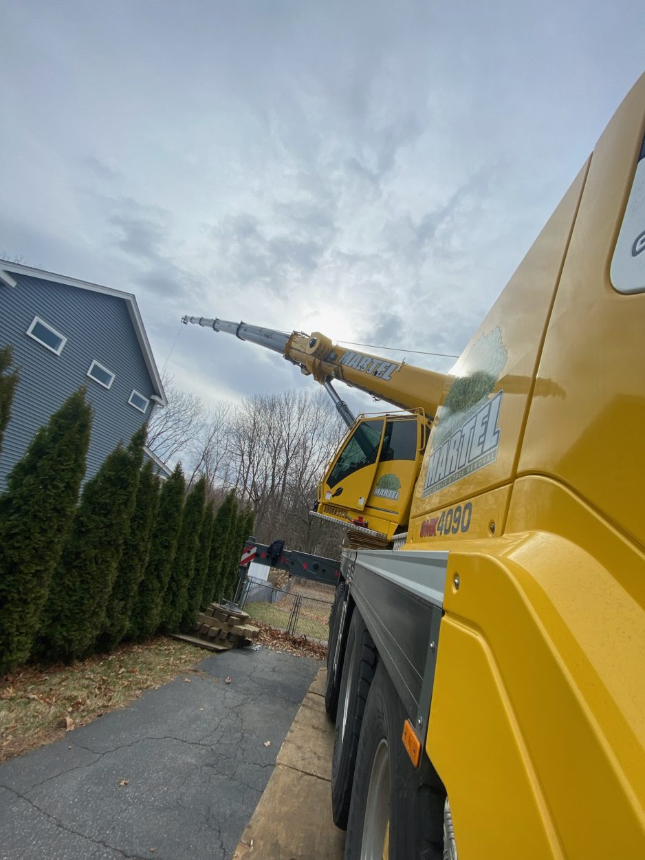 For this job in Burlington, MA, Martel Crane & Tree setup in the driveway to safely remove trees from the property.

