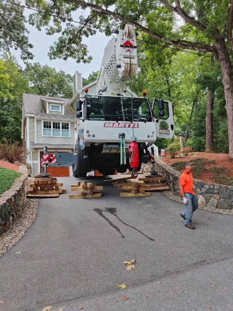 Martel Crane Service & Tree Removal removed trees from this residence in Chelmsford, MA. We used a crane on blocks to protect the customer's driveway. 

