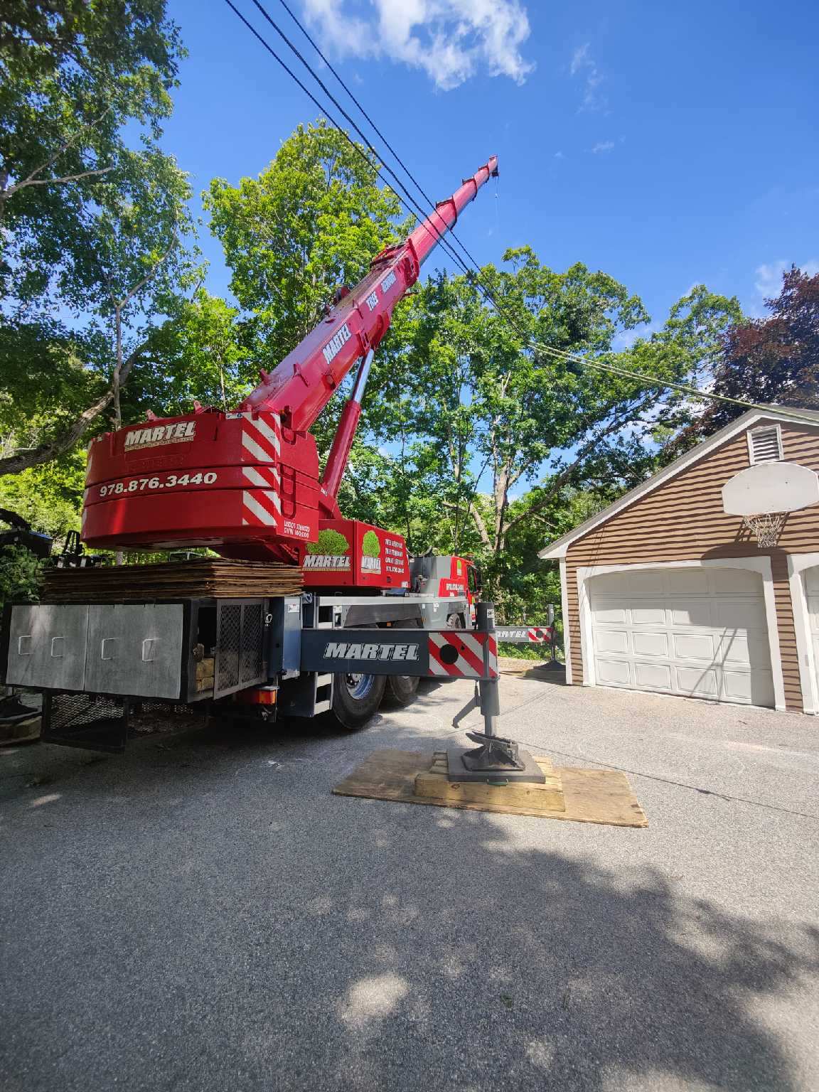 The crane and crew safely removed multiple trees from this property in Andover, MA.