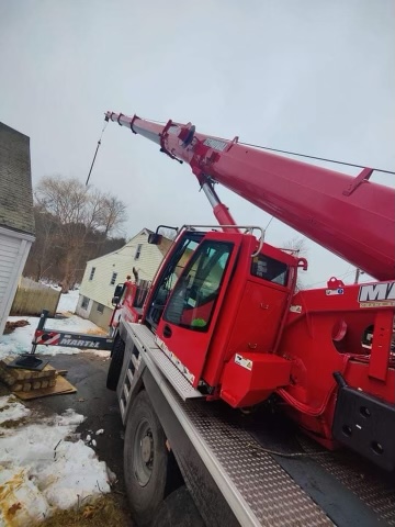 We setup the crane in the driveway of this property in Wilmington, MA to safely remove damaged trees after the recent storms.